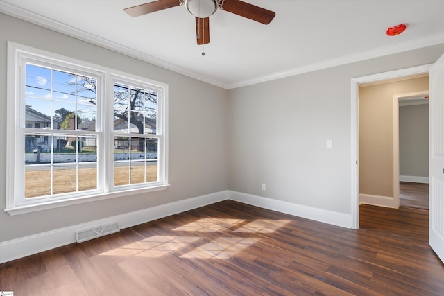 empty room with ceiling fan, ornamental molding, and dark hardwood / wood-style floors