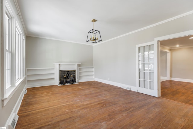 spare room featuring dark wood-type flooring and ornamental molding