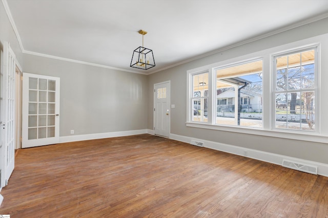 spare room featuring crown molding and dark hardwood / wood-style floors