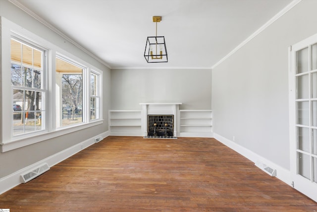 unfurnished room featuring crown molding, dark wood-type flooring, and built in shelves