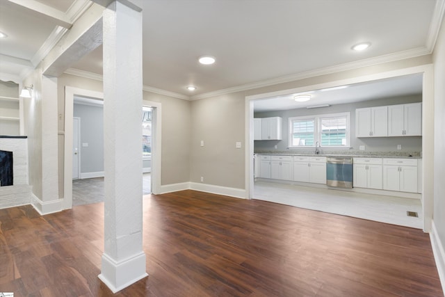 unfurnished living room featuring ornamental molding, dark wood-type flooring, and a fireplace