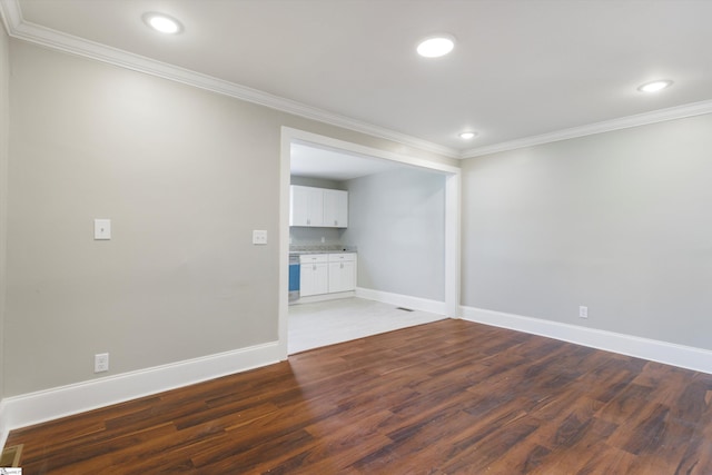 empty room featuring ornamental molding and wood-type flooring