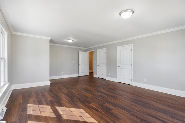 empty room featuring dark hardwood / wood-style flooring and crown molding