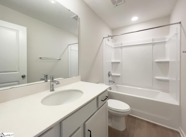 full bathroom featuring wood-type flooring, toilet, shower / bathtub combination, and vanity