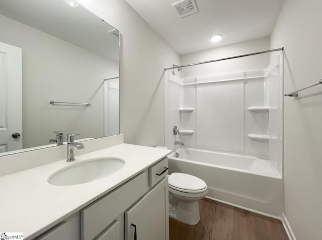 full bathroom featuring shower / washtub combination, wood-type flooring, toilet, and vanity