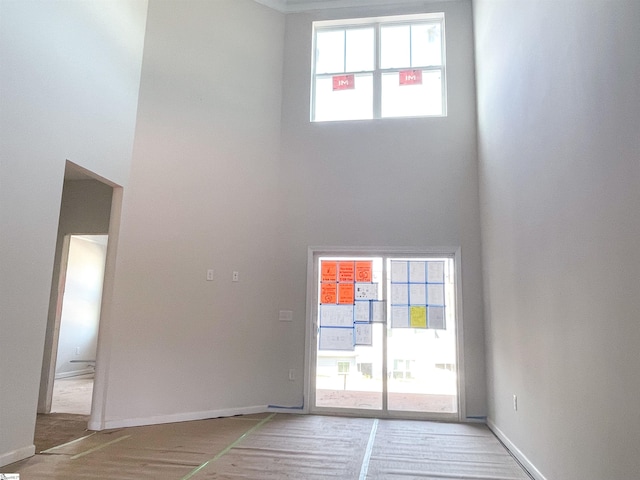 interior space with plenty of natural light and hardwood / wood-style flooring