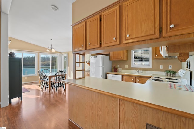 kitchen with a chandelier, decorative light fixtures, white appliances, lofted ceiling, and dark hardwood / wood-style floors