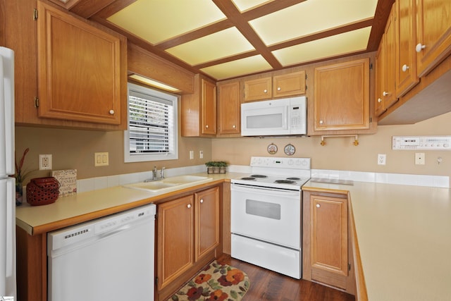 kitchen with white appliances, dark hardwood / wood-style floors, and sink