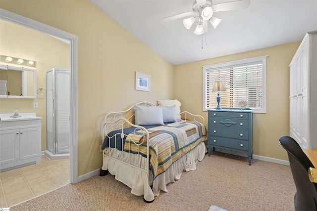 carpeted bedroom with connected bathroom, lofted ceiling, ceiling fan, and sink