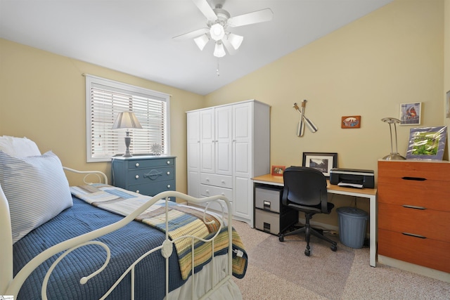 carpeted bedroom with ceiling fan, lofted ceiling, and a closet