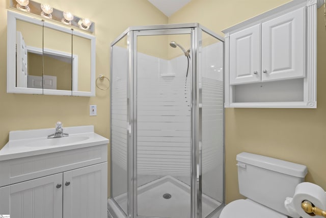 bathroom with oversized vanity, toilet, and a shower with door