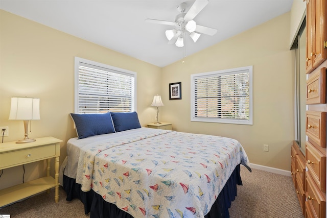 carpeted bedroom with lofted ceiling, ceiling fan, and multiple windows