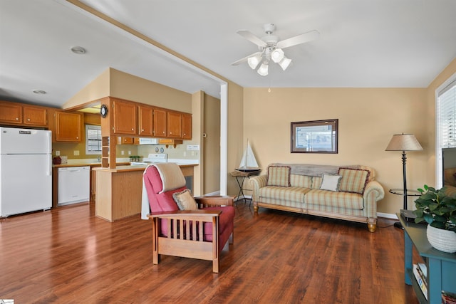 living room featuring dark hardwood / wood-style flooring, ceiling fan, and vaulted ceiling