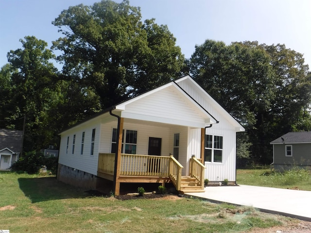 view of front of property featuring covered porch and a front yard