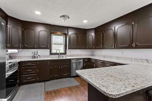 kitchen with stove, dark wood-type flooring, dark brown cabinetry, dishwasher, and sink