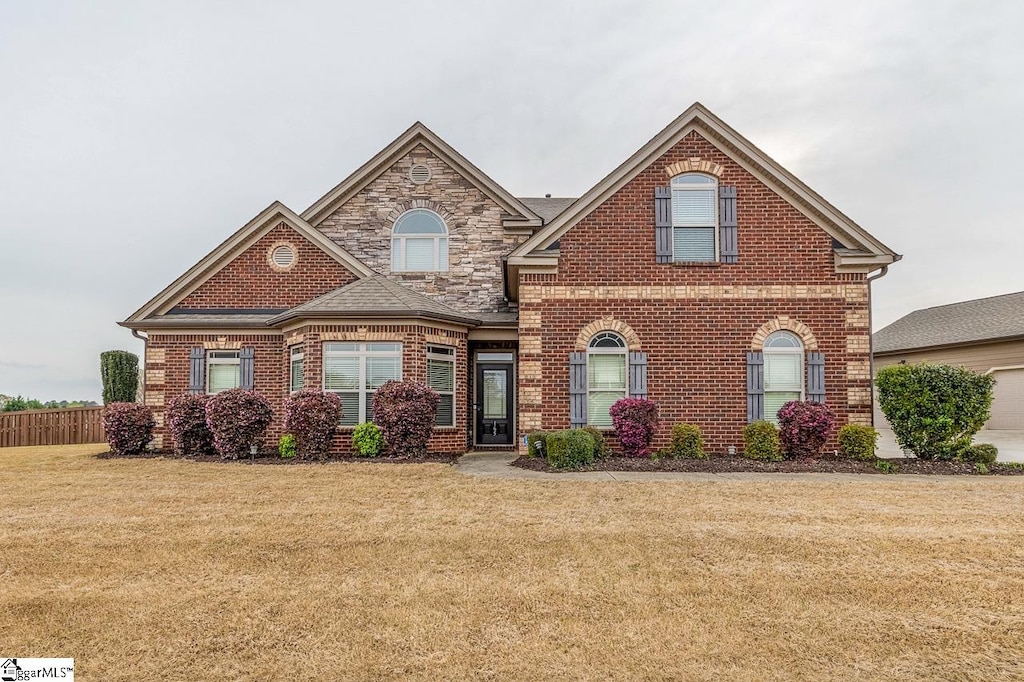 front of property with a front lawn and a garage