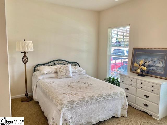 bedroom with light colored carpet