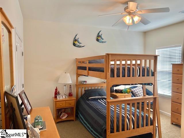 bedroom featuring light carpet and ceiling fan