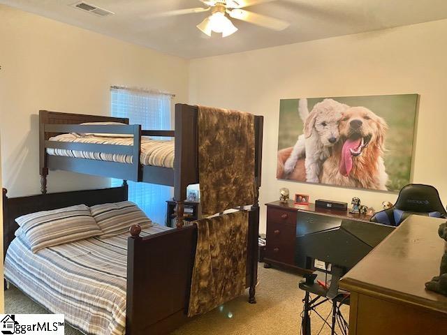 carpeted bedroom featuring ceiling fan