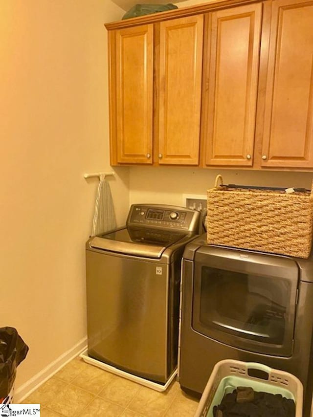 laundry area featuring cabinets, washer hookup, separate washer and dryer, and light tile floors