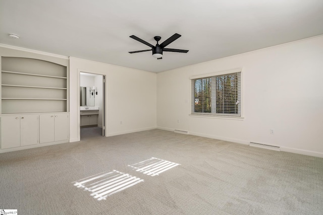 unfurnished bedroom with ceiling fan, baseboard heating, light colored carpet, and ensuite bath