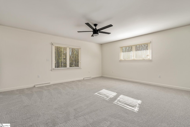 carpeted spare room featuring ceiling fan