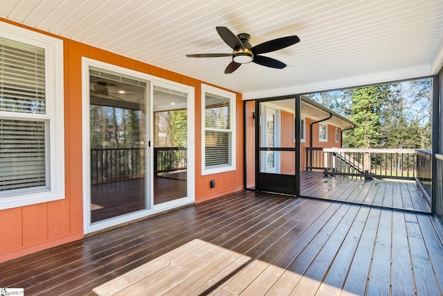 unfurnished sunroom featuring ceiling fan