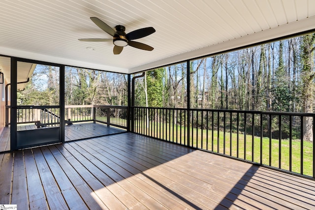 unfurnished sunroom with ceiling fan