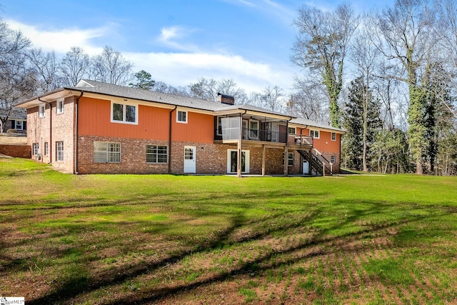 rear view of house featuring a lawn