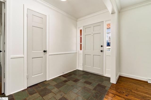 entrance foyer featuring dark tile flooring and crown molding