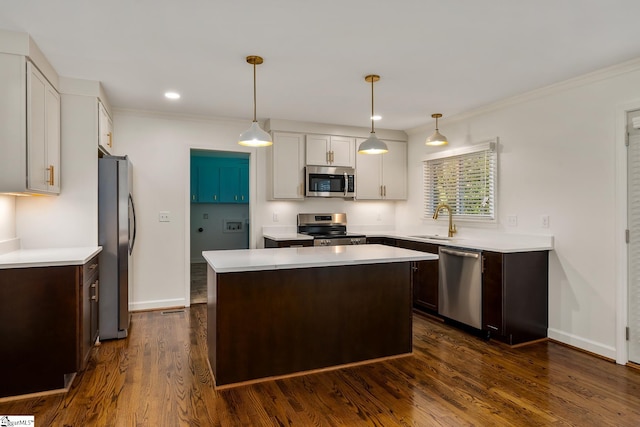 kitchen with pendant lighting, stainless steel appliances, dark wood-type flooring, and a kitchen island