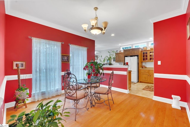 tiled dining area with a notable chandelier and ornamental molding