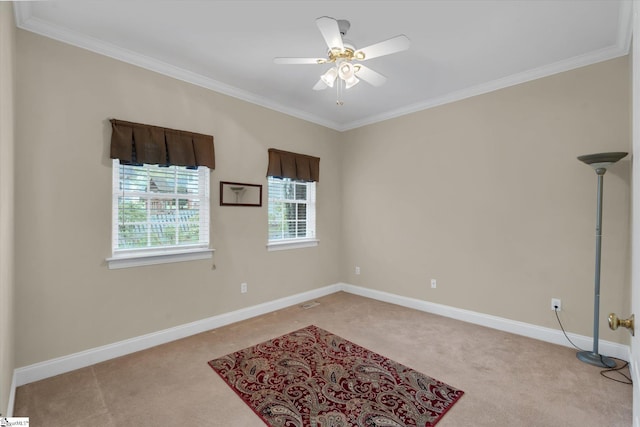 empty room featuring light carpet, ornamental molding, and ceiling fan