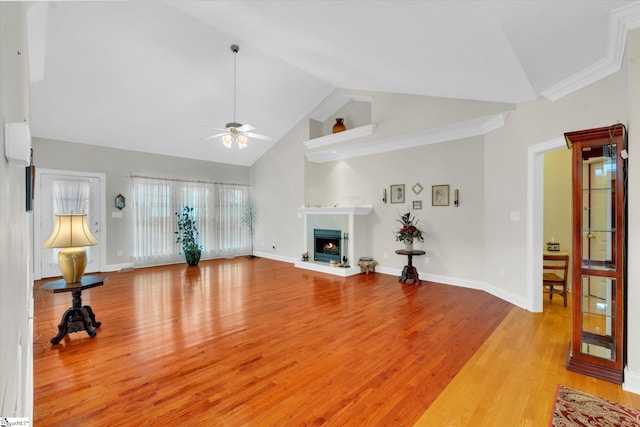 living room featuring high vaulted ceiling, ornamental molding, ceiling fan, and light wood-type flooring