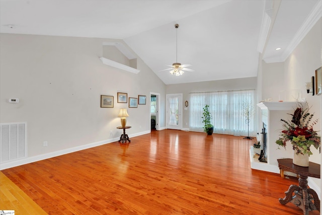 interior space with high vaulted ceiling, ceiling fan, and light wood-type flooring