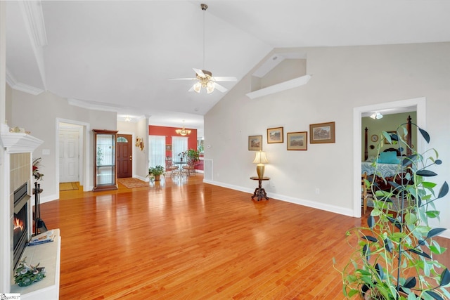 interior space featuring a fireplace, crown molding, light hardwood / wood-style flooring, and ceiling fan