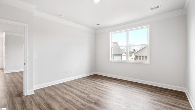 unfurnished room featuring ornamental molding and hardwood / wood-style floors