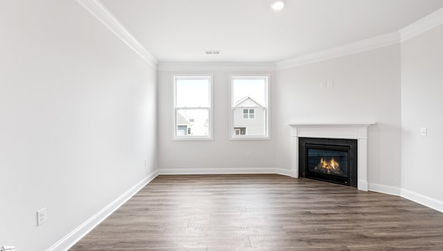 unfurnished living room featuring hardwood / wood-style floors and ornamental molding