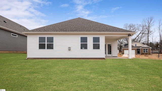 rear view of property with a lawn