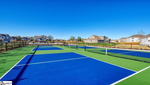 view of tennis court with basketball hoop