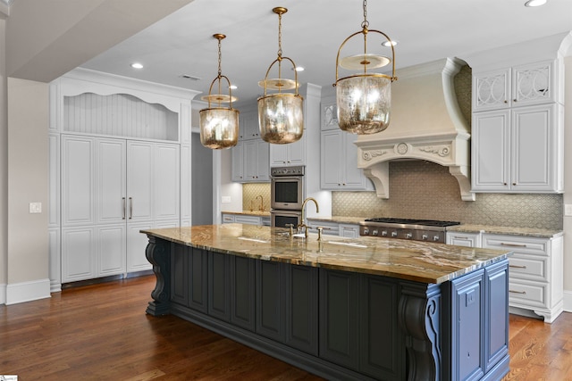 kitchen with dark wood-type flooring, white cabinetry, dark stone countertops, custom exhaust hood, and backsplash