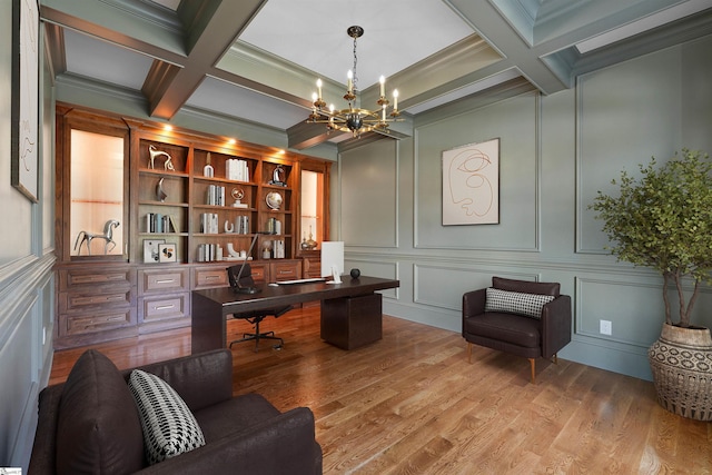 office featuring crown molding, an inviting chandelier, coffered ceiling, beam ceiling, and hardwood / wood-style flooring