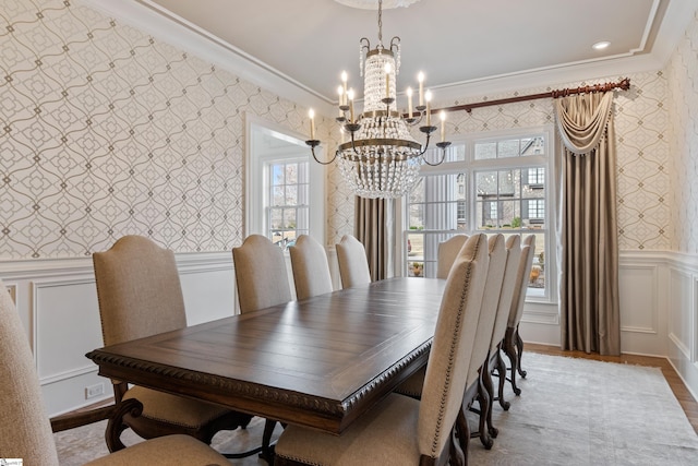 dining room featuring a chandelier, light wood-type flooring, and ornamental molding