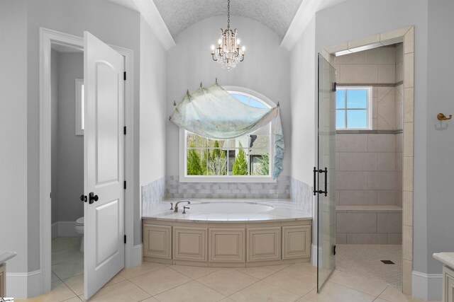 full bathroom with plenty of natural light, toilet, tile floors, and a chandelier