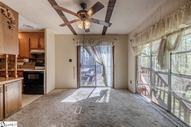 unfurnished living room featuring light colored carpet and ceiling fan