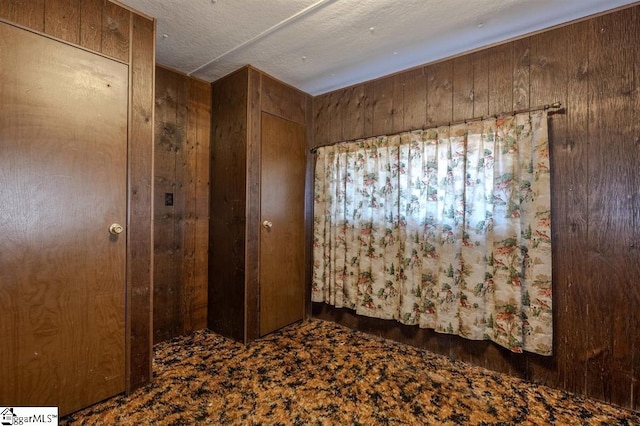 spare room featuring wooden walls