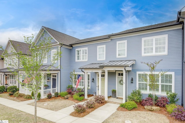 townhome / multi-family property featuring a porch