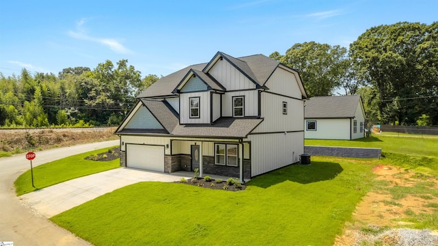 view of front of home featuring a front lawn, a garage, and central AC