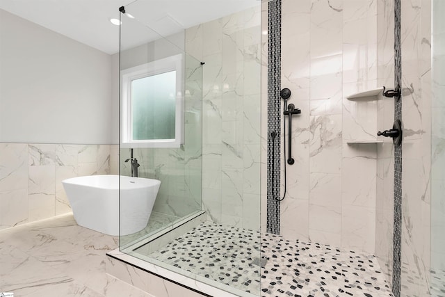 bathroom with tile floors, shower with separate bathtub, and tile walls