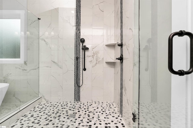 bathroom featuring a shower with door